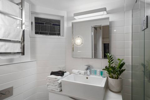 The ensuite bathroom includes a shower, vanity and sink and heated towel rail so you can enjoy warm fluffy towels when you hop out of the shower. The leadlight window is from the original villa.