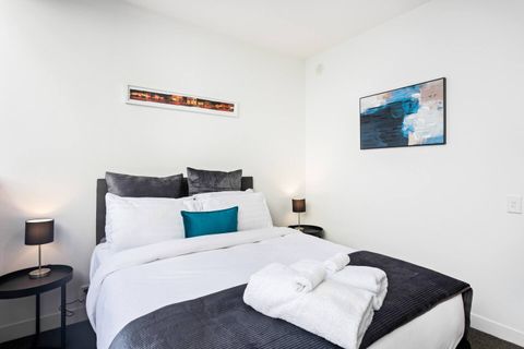 Lovely warm tones of dark grey and turquoise blue make this an inviting bedroom to sleep in.