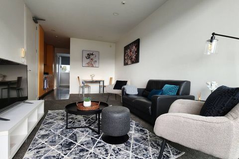 Plenty of seating in this apartment from the comfy couch to the armchairs.