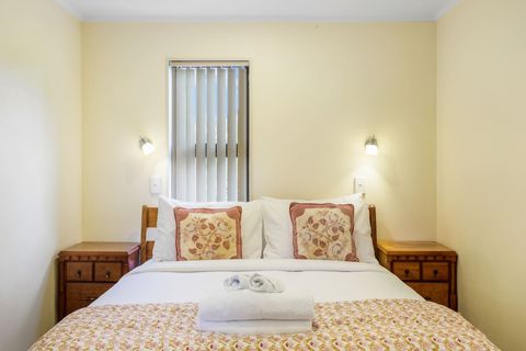 This bedroom has a queen bed and two bedside cabinets.