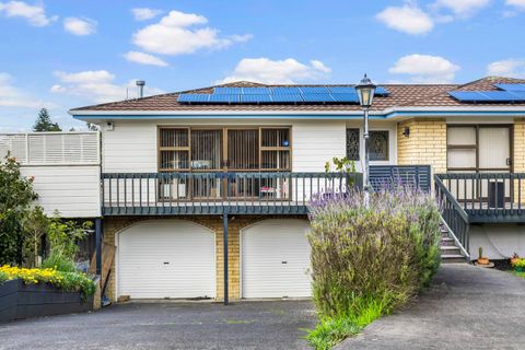 The front-facing exterior features beautiful lavender plants and a garden bed along the drive, with access to the 1 bedroom unit next to the garage.