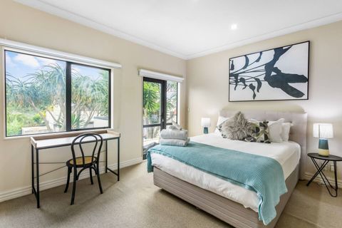 The main bedroom has a Queen bed with a desk for work or study.