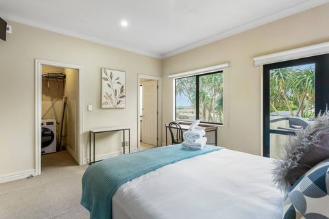 The main bedroom has a large wardrobe, ensuite bathroom and in-unit combo washer and dryer.