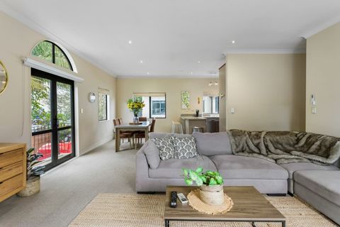 The open-plan living area encompasses a large kitchen, dining space, and lounge.