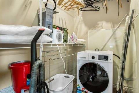 The large wardrobe in the main bedroom comes with laundry facilities.
