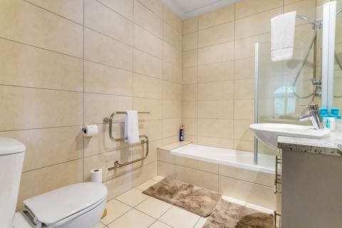 The main bathroom also has a vanity, toilet and heated towel rail.