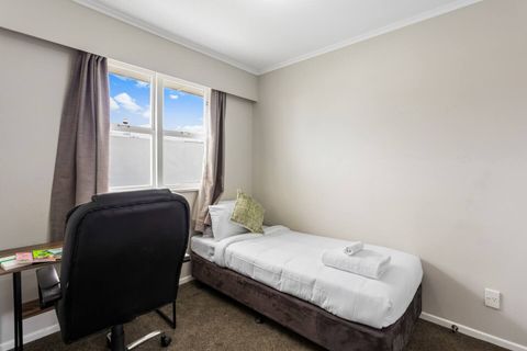 The second bedroom features a single bed setup and a small desk for study or work.