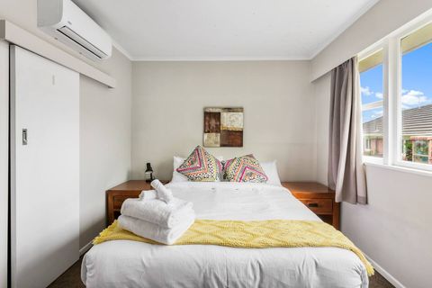 The first bedroom features a queen bed setup, aircon unit, and modern interior design.
