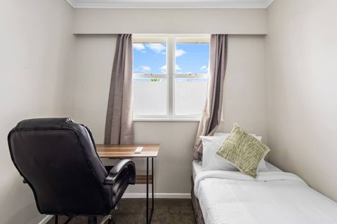 The second bedroom is a cosy space with a single bed and desk setup.