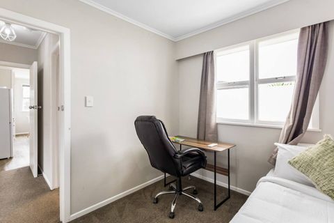 The single room features a small desk near the windows