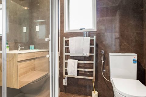 The full-sized bathroom has heated handrails, a shower, a wash basin, and a toilet.