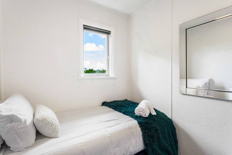 The mirror reflects the light and makes the room appear larger.