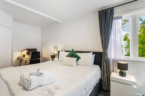 Snuggle under the sheets in this calming bedroom to rest and relax.