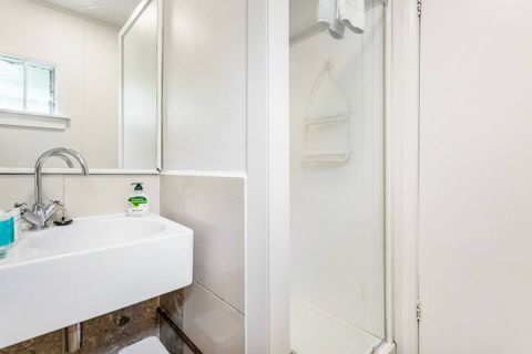 The bathroom has a shower, sink, and toilet for the whole family.