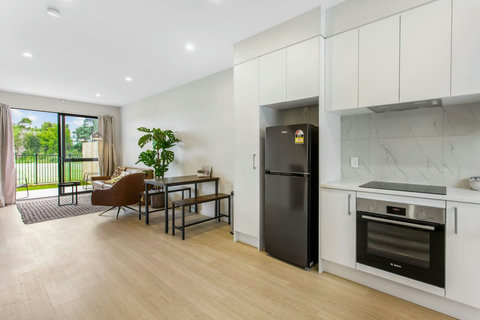 Open plan kitchen area with fridge and freezer.