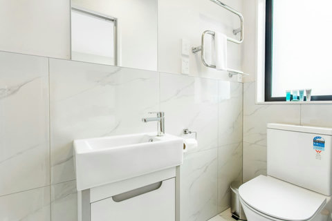 Bathroom with heated towel rail and basin.