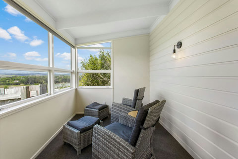 Sunroom with comfy seating looking towards estuary.