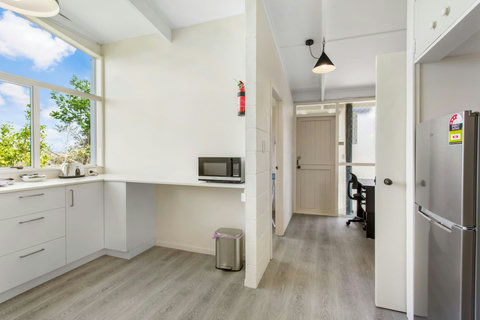 The kitchenette, though lacking an oven, is well-equipped for culinary endeavors.