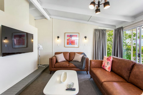 Pops of colour on the wall and couch, invite you into this space.