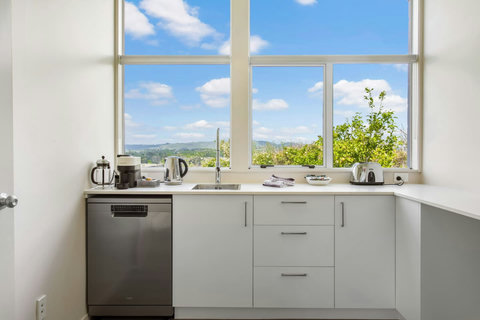 Bright kitchenette area with great view.