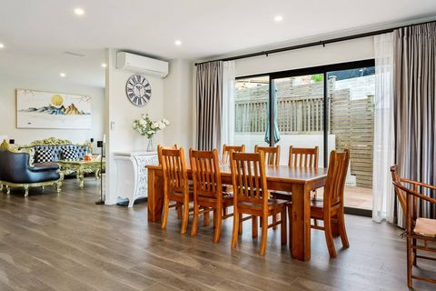 Main dining table that seats 8 people. Ranchslider opens onto deck with the lounger furniture outside.