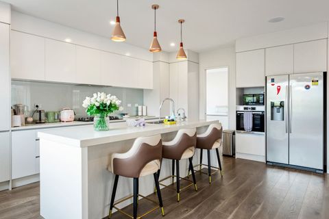 Light and bright kitchen with double door fridge/freezer and view into second kitchen.