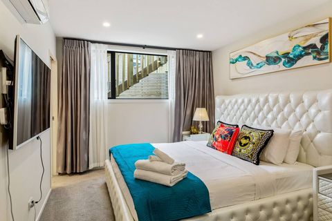 Large screen TV, crisp white linen and the beautiful blue that matches the artwork entices you to bed.