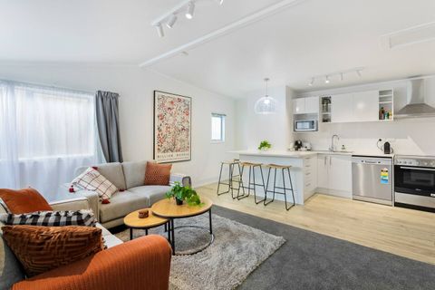 Broken into zones by the carpet and wooden floors, is this lovely lounge and kitchen area.