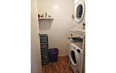 The laundry is in a separate area with a washing machine, dryer, and wash tub.
