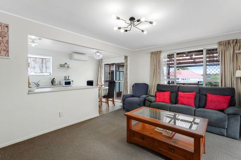 Open-plan living, dining and kitchen area with access to the deck via the dining room.