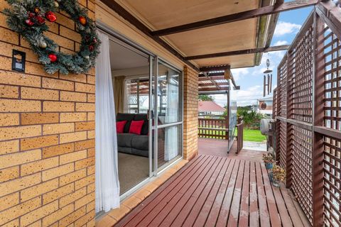 The deck runs around the house with two ranch sliders opening from the house.