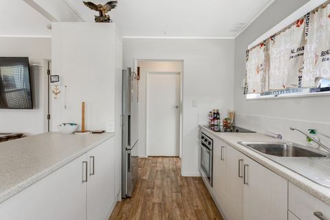 The galley-style kitchen has an oven, cooktop, microwave, dishwasher and fridge/freezer.