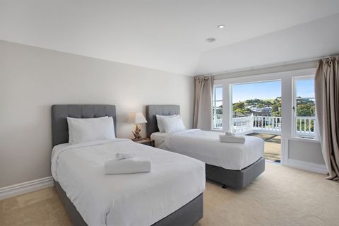 The third bedroom has two King-single beds and a double wardrobe. You can open the French doors to access the balcony.