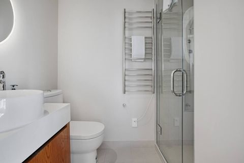 The second bedroom's ensuite bathroom has a shower, vanity and toilet.