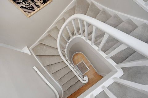 The staircase leads from the top to the bottom. The bedrooms are on the top floor, and all the living spaces are on the ground floor.