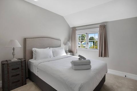 The fourth bedroom has a Queen-sized bed and a double wardrobe. It has lots of sunlight through the windows.