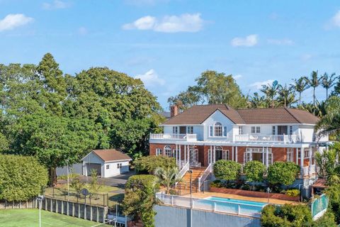 The view of the house with swimming pool and wrap-around verandah.