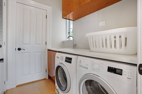 The laundry has a washer and dryer. The separate toilet and vanity are through this door. Pro tip: There is a hidden laundry shoot upstairs that goes straight to this laundry cupboard—see if you can find it.