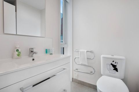 The ensuite bathroom has a shower, vanity and toilet.