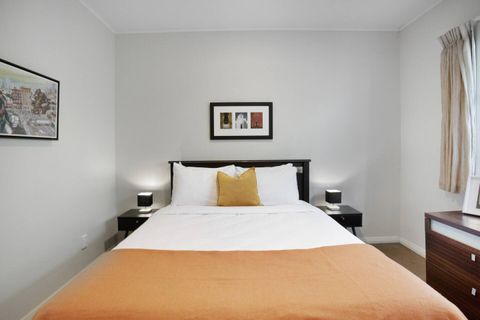 The other large bedroom also has a Queen bed with mustard soft furnishings.