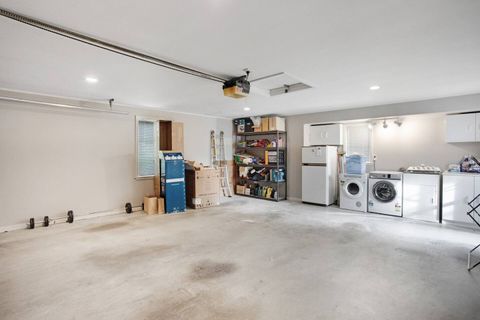 The laundry area is in the double garage and has a washing machine and dryer.