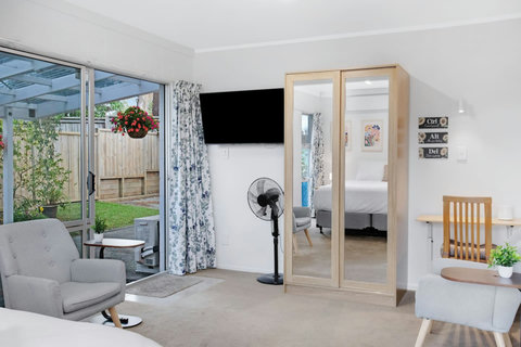 The living room has two comfortable chairs for lounging around and a desk area if you need to study or work.