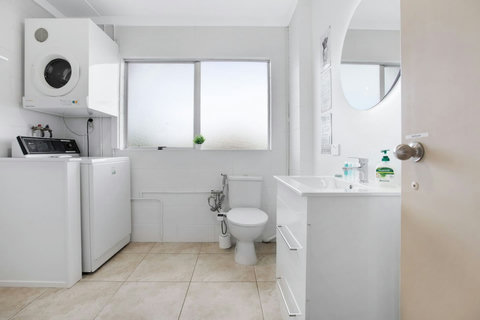 The washing machine and dryer are conveniently located in the bathroom .