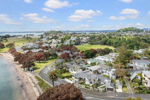 View of the property with the Narrow Neck beach in the foreground around Takapuna Head in the background.