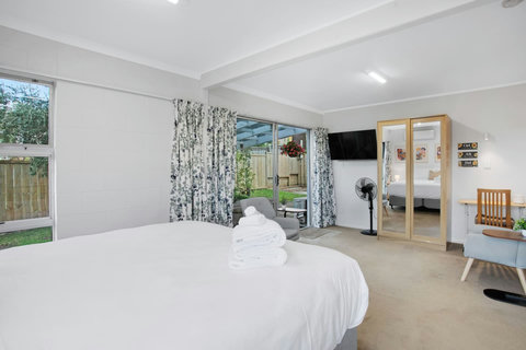 Lay in bed and watch TV or lounge on the chairs in the living room area.