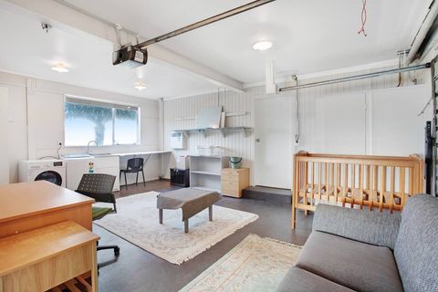 The garage has a couch, desk, laundry area and cot. Would be great for the teens to hang out together.