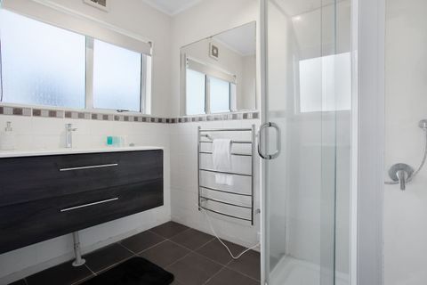 The family bathroom has a shower, vanity, and heated towel rail.