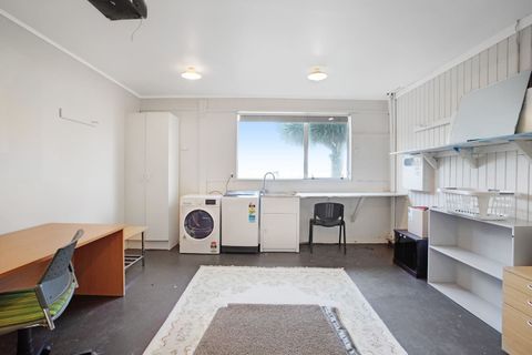 The laundry area is in the garage area, that also contains the desk and cot.