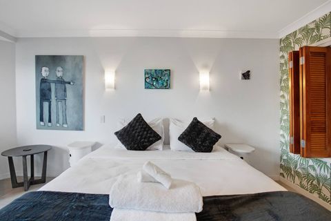 The Queen bed has pops of colour on the throw and cushions that brings out the colour in the artwork.