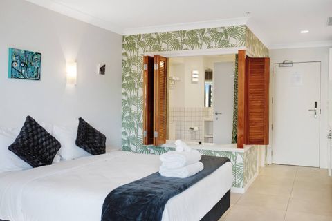 View into the bathroom from the living areas with the shutter windows open.